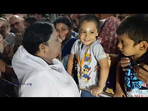 Amma hugging and kissing kids
